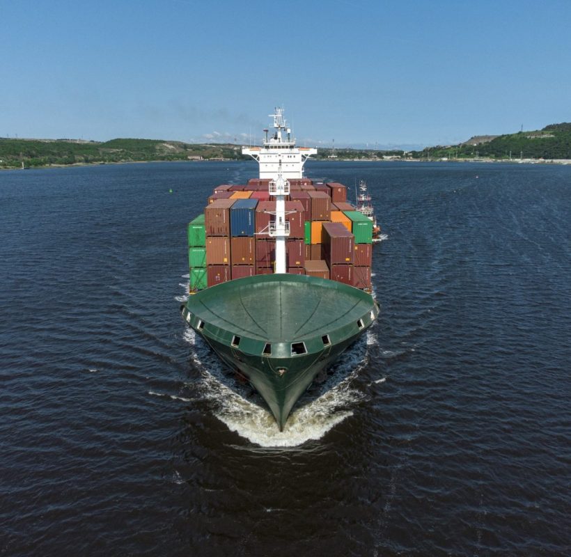 aerial-view-of-cargo-container-ship-in-the-sea-e1657115733536-prdavjklxqi8kds0w6yv1dnrey4wotr3suqiej6q0w